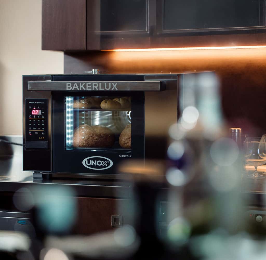 commercial convection oven on a counter baking bread