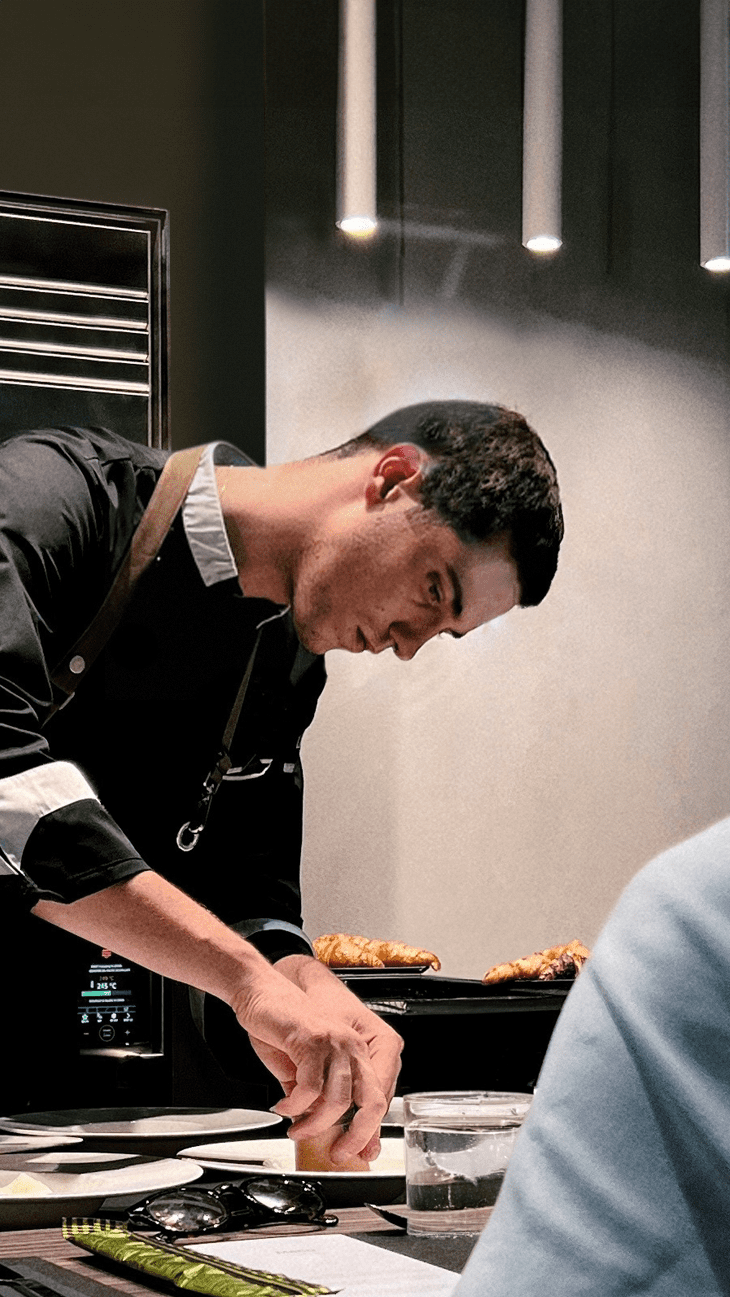 chefkoch beim kochen mit einem professionellen cheftop vista  ofen während eines chef's tables
