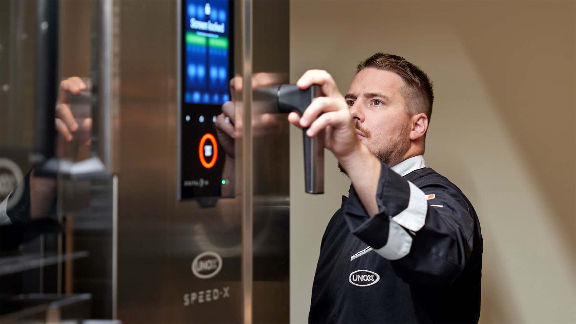 A chef cooking with a commercial speed oven 